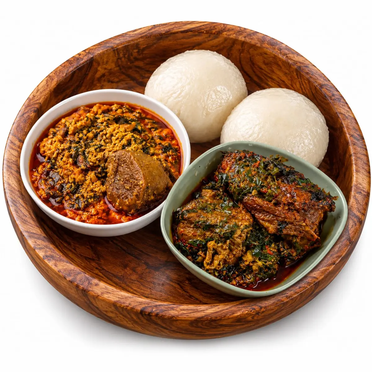 Egusi soup and efo with pounded yam in a wooden bowl